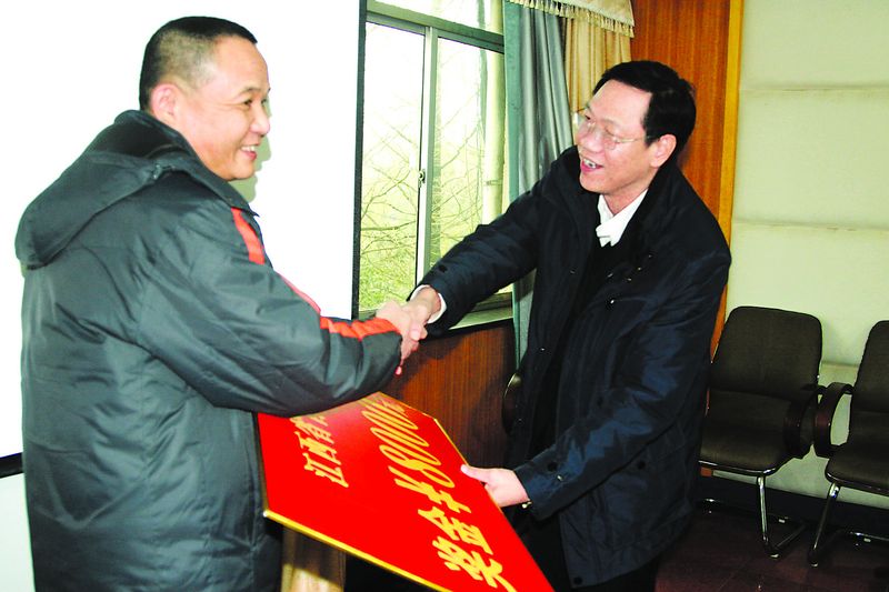 近日，江铜集团副总经理龙子平（右）到永平铜矿看望、慰问劳动模范，并把慰问金送到每位劳动模范的手中。图为龙子平把8000元奖金奖给江西省首席技师兰师明。