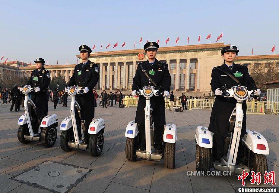 十二届全国人大一次会议在北京人民大会堂召开，警察骑着电动车在天安门广场上巡逻。